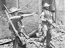 British officers: Brigadier "Mad" Mike Calvert (left) gives orders to Lieutenant-Colonel Shaw, while Major James Lumley stands with M1 carbine under his arm, after the capture of Mogaung in Burma during the second Chindit expedition, June 1944. The Chindits MH7287.jpg