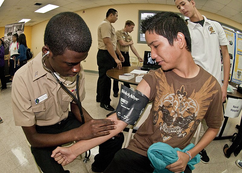 File:US Navy 101215-N-3620L-021 A Sailor shows Southern High School students how to take a blood pressure reading during Military Day at the school.jpg