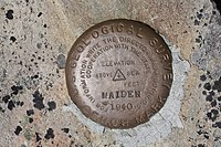 Bronze disc set in concrete