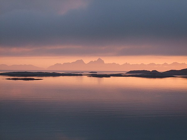 The Vestfjorden with the mountains of the Lofoten archipelago seen from Løvøy Island in Steigen. Vågakaillen (942 m) is the taller of the two peaks in