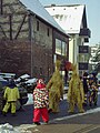 Straw bears in the street in Walldürn (Neckar-Odenwald district, Baden-Württemberg) with brightly dressed attendants.