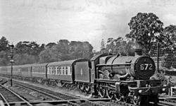 The 07:30 Penzance - Wolverhampton express headed by 4-6-0 No. 5057 Earl Waldegrave enters Wellington station, 28 August 1954 Wellington (Somerset) running down through geograph-2899538-by-Ben-Brooksbank.jpg