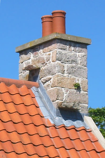 File:Witches' stones on tiled roof Jersey.jpg