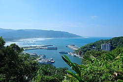 The coast of Huanggang was inundated by a tsunami up to 7 meters high. The trace of the Shanchiao Fault is located at the base of the hills. 2020 Huanggang Fishing Port i.jpg