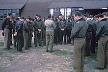 Captain Wilbur C. Ziegler, station Chaplain, leads pilots of the 359th Fighter Group in prayer at East Wretham.