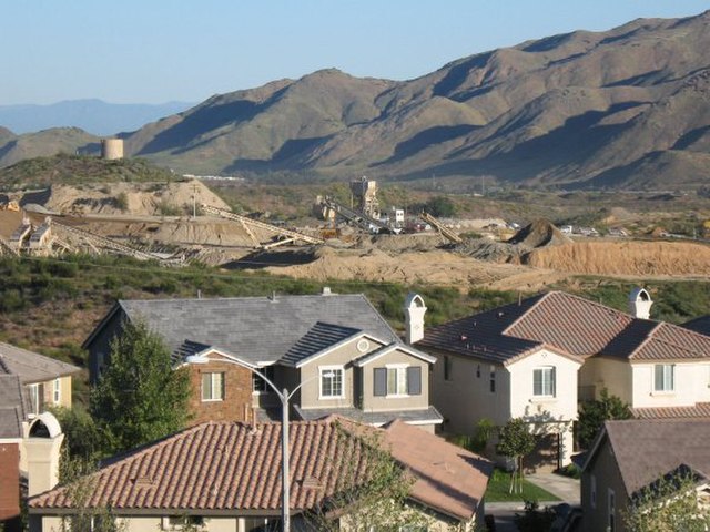 Newly constructed housing tract in the Alberhill Ranch neighborhood. Pacific Clay Products company mine in background.