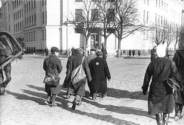 1942 photo showing Jews in Riga required to wear the yellow star and forbidden to use the sidewalk