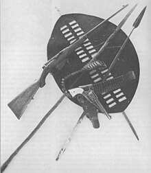 Rhodesiana exhibited at Bulawayo Museum, 1912. Weapons and bandoliers used by Frederick Russell Burnham during the Second Matabele War mingle with assegais and a tribal shield. Burnham africaweapons.jpg