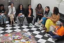 A group of people sitting in a circle having a conversation