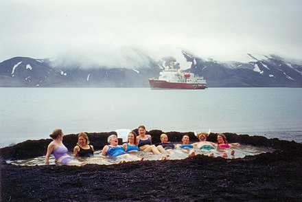 Bathing in hot springs on Deception Island as part of an Antarctic cruise
