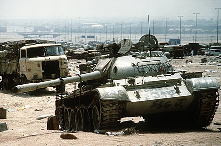 A destroyed Iraqi Army T-55 tank lies among the wreckage of many other Iraqi vehicles, such as trucks, cars and buses, somewhere along the Highway of Death in April 1991.