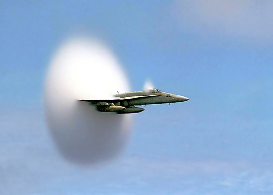 U.S. Navy F/A-18 approaching the sound barrier. The white cloud forms as a result of the supersonic expansion fans dropping the air temperature below the dew point.[1][2]