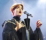 "Sweet Nothing" features Florence Welch (pictured), who received favourable reviews from music critics, for delivering "tamed", but "special" vocals. Florence Machine (Florence Welch).jpg