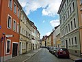 Streets of Nikolaivorstadt with sidewalks and granite paving and city wall of the suburb