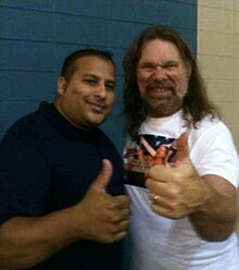 "Hacksaw" Duggan poses with a fan at an independent show in 2013 Hacksawjd.jpg