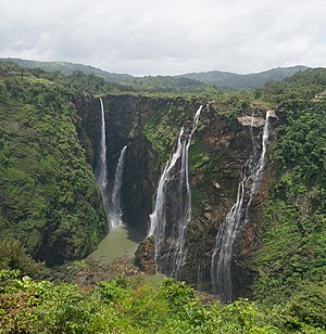 Wide photo of large waterfall in mist
