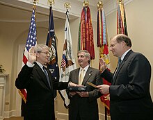 Bolten is sworn in as White House Chief of Staff by his Deputy Joe Hagin; his predecessor Andrew Card looks on. Joshua Bolten, Andrew Card, Joe Hagin.jpg