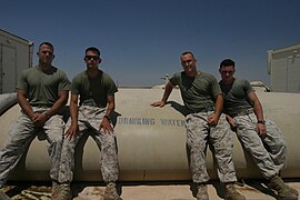 Marines of the Reverse Osmosis Water Purification Unit team sit on a 20,000 gallon tank of water .jpg