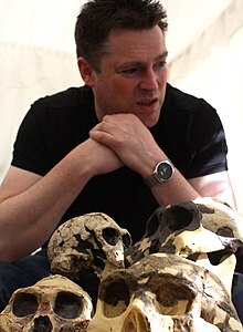 Mark Maslin at the Cheltenham Science Festival Mark Maslin and hominin skulls.jpg