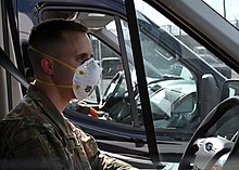 A member of the Maryland National Guard before transporting passengers from Grand Princess Maryland National Guard (49676182507).jpg