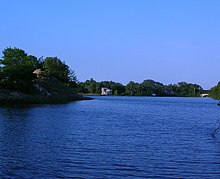 The middle of the three Grand Calumet Lagoons in Miller Beach. The lagoons mark the former mouth and modern-day headwaters of the Grand Calumet River. Miller Lagoon toward Lake Street.jpg