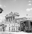 British soldiers queue for tea at NAAFI Mobile Canteen No.750 beside the Brandenburg Gate, Berlin. This van was the first mobile NAAFI to operate in Berlin, 16 July 1945