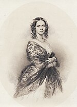 photograph of lady in dress and shawl, pearl necklace, body facing right, smiling face facing viewer