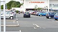 English: Markings in the car park of the Sainsbury's supermarket in Newport, Isle of Wight. Until a couple of years ago, bus services used to call in to the internal bus stop in the car park, outside the main entrance to the store. Yellow "bus" markings and arrows were painted when the store first opened, to show buses where to go. It seemed rather pointless, as there is only one way to get to the bus stop, and the regular service bus drivers would know the route anyway, but presumably it helps other large vehicles visting the store.