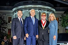 John after being awarded the National Humanities Medal by United States President Joe Biden in September 2022 President Biden presented Sir Elton John with the National Humanities Medal.jpg