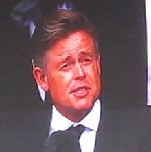 Phillipson as John F. Kennedy at the Rebild Festival 2022 delivering the 1962 "We choose to go to the Moon" Rice University speech President John F. Kennedy (impersonated by Caspar Phillipson) giving a speech at the Rebild Festival 2022 (cropped).jpg