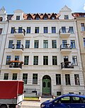 Apartment building with shop in closed development, with front garden