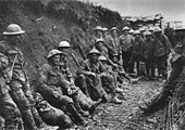 Mud stained British soldiers at rest