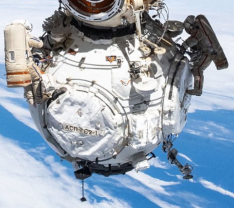 Russian Spacewalkers dwarfed by the Prichal module (cropped).jpg