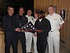 The cast and crew of Star Trek: Enterprise are presented with a flag from the U.S. Navy aircraft carrier Enterprise.