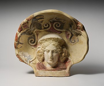 Etruscan antefix from Cerveteri of a maenad wearing an elaborate diadem and grape-cluster earrings, The MET