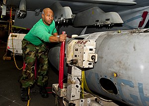 US Navy 120118-N-FI736-070 Aviation Machinist's Mate 2nd Class Shawn Mack, assigned to Strike Fighter Squadron (VFA) 136, moves an extended fuel ta.jpg