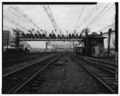 VIEW EAST TOWARD STAMFORD ANCHOR BRIDGE -374 OF CIRCUIT BREAKER INSTALLATION ON CROSS BEAM OF BRIDGE. - New York, New Haven and Hartford Railroad, Bridge-Type Circuit Breakers, HAER CONN,1-COSCOB,2C-3.tif