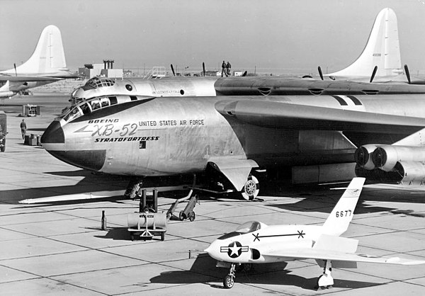 XB-52 prototype on flight line (X-4 in foreground; B-36 behind). Note original tandem-seat "bubble" style canopy, similar to Boeing's earlier B-47 Str