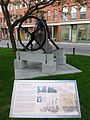 'Bell City' historical plaque and Naylor Vickers & Co. 1860 bell. Front and right side of bell shown. Located at the intersection of Prescott Street and Central Street in Lowell, Massachusetts.