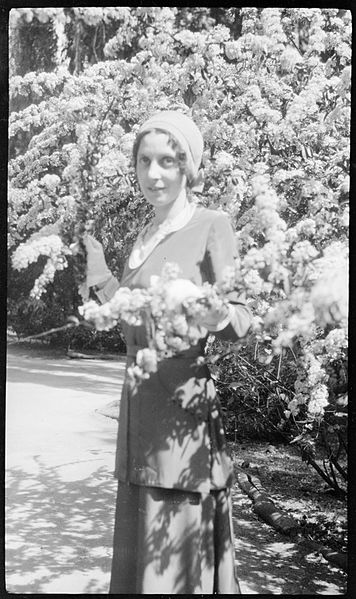 File:(Unidentified woman standing between branches with blossoms on) (Frank Hurley) (9711322629).jpg