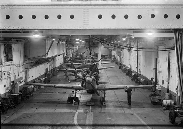 Five Sea Hurricanes and a single Seafire lined up in the hangar, c. 1942–1944