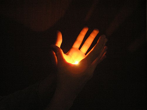 An amateur "flame-in-hand" illusion with a hidden tealight candle