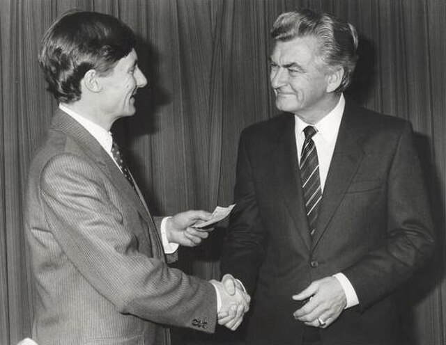A cheque for Ash Wednesday bushfire relief to South Australian Premier John Bannon is presented by Hawke in April 1983.