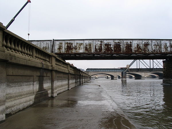 The Des Moines River, as it flows through downtown Des Moines, west bank, during spring high water; note the old watermarks on the flood wall.