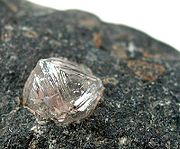 a lump of rock, with a large colorless crystal embedded into it