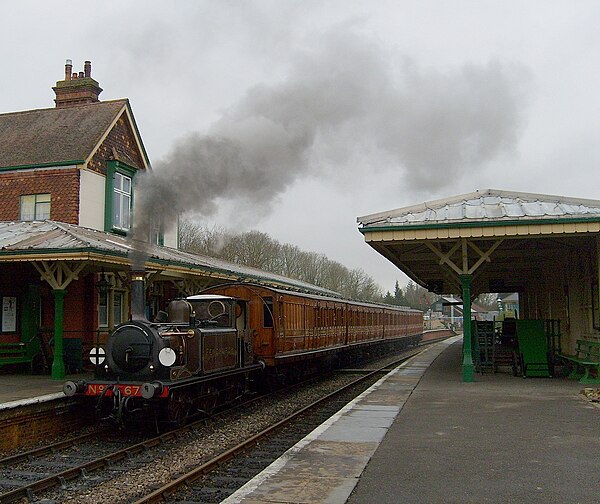 No.672 'Fenchurch' carrying the later LB&SCR umber livery. It is seen at Kingscote with a train of Metropolitan Railway carriages.