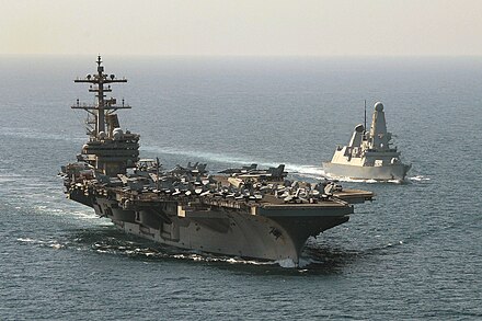 Royal Navy destroyer HMS Defender (D36) escorts the American aircraft carrier USS George H.W. Bush (CVN-77) through the Middle East during Operation Shader.