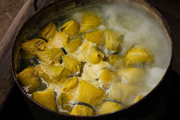 Wrapped humitas being cooked