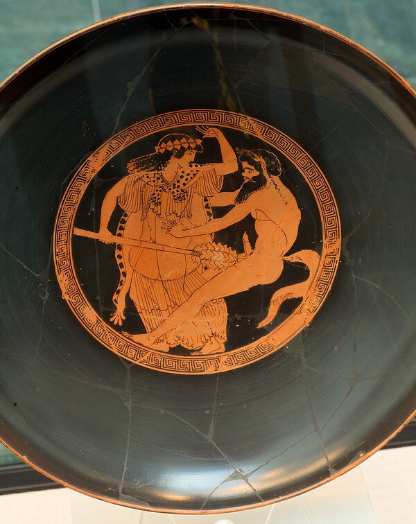 A drinking cup, c. 490–480 B.C., depicting a maenad and a satyr.