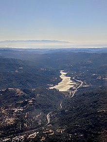 Lexington Reservoir aerial, from the north, with Monterey Bay and the Monterey Peninsula in the background